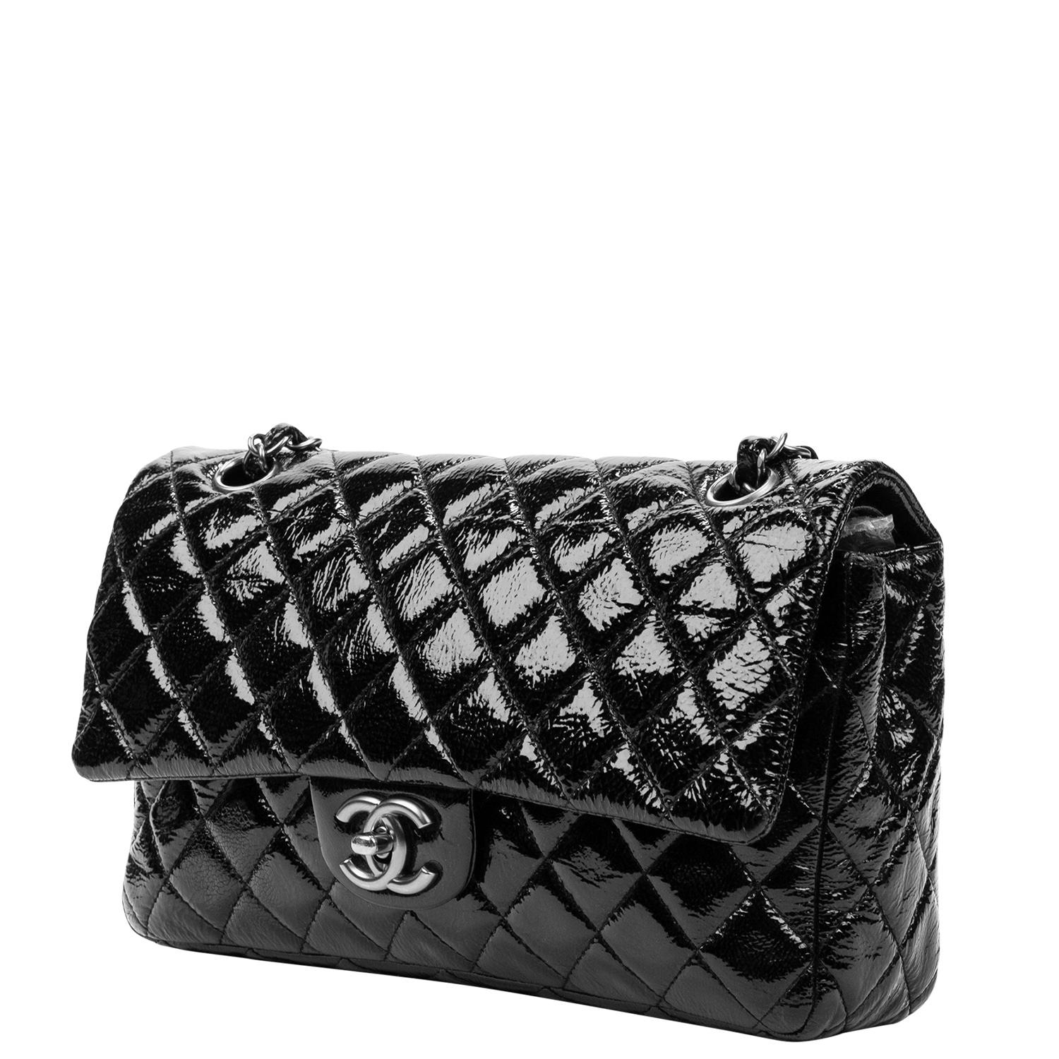 Mid 2000s classic that every collector needs in their collection! This diamond quilted beauty is crafted in a glossy black patent leather, antiqued silver-tone hardware, chain-link leather threaded shoulder strap, and a single exterior pocket. The