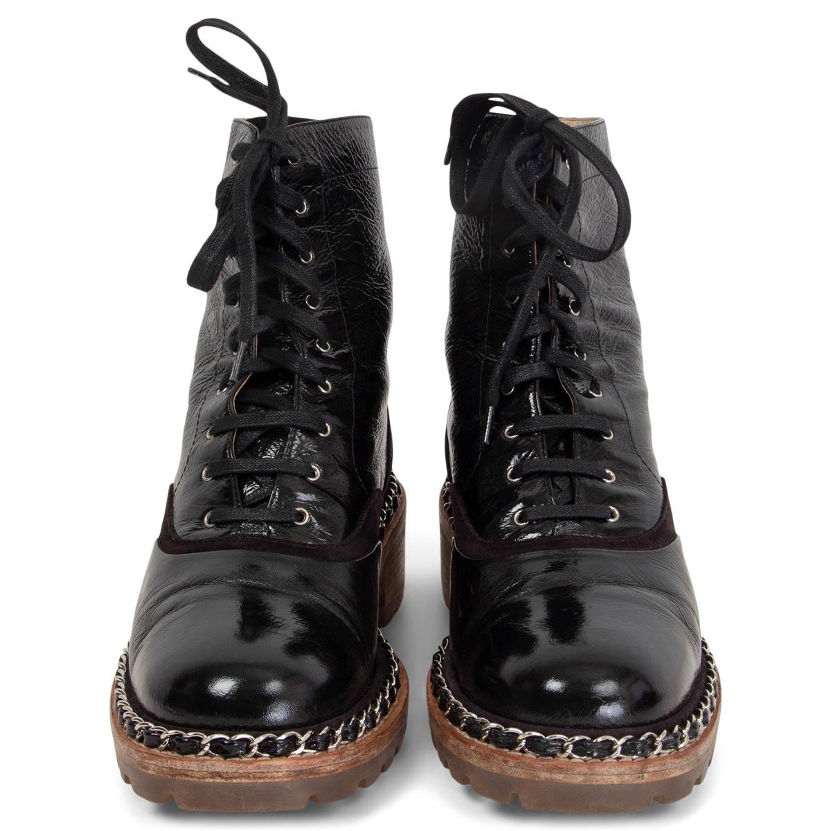 100% authentic Chanel 2015 Salzburg lace-up silver chain detailed ankle-boots in black wrinkled patent leather with details in suede. Boots have a brown stacked heel and a clear rubber sole. Have been worn and are in excellent condition. Come with