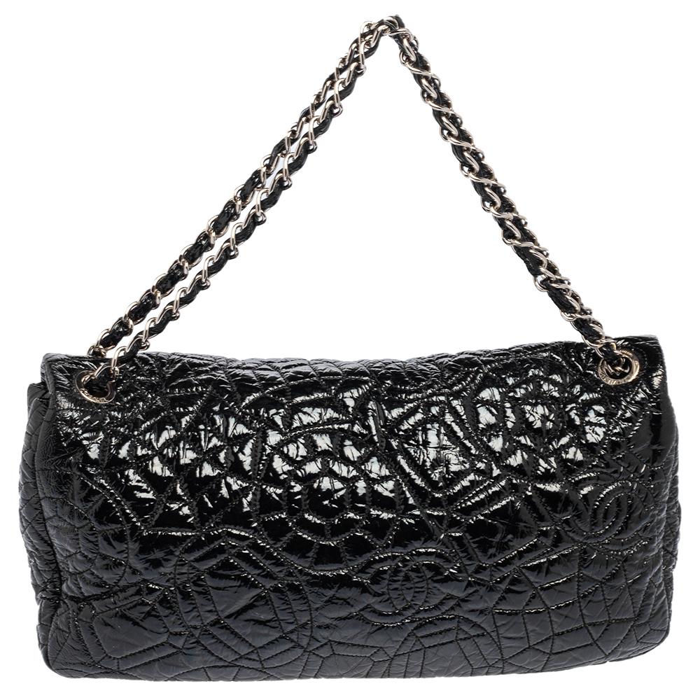 Bold and edgy, this Classic flap style bag is designed from a black-hued patent vinyl with a graphic pattern on it. Ideal for evenings, this bag comes topped with two sleek chain straps and is secured with a 'CC' lock closure. It comes with a satin