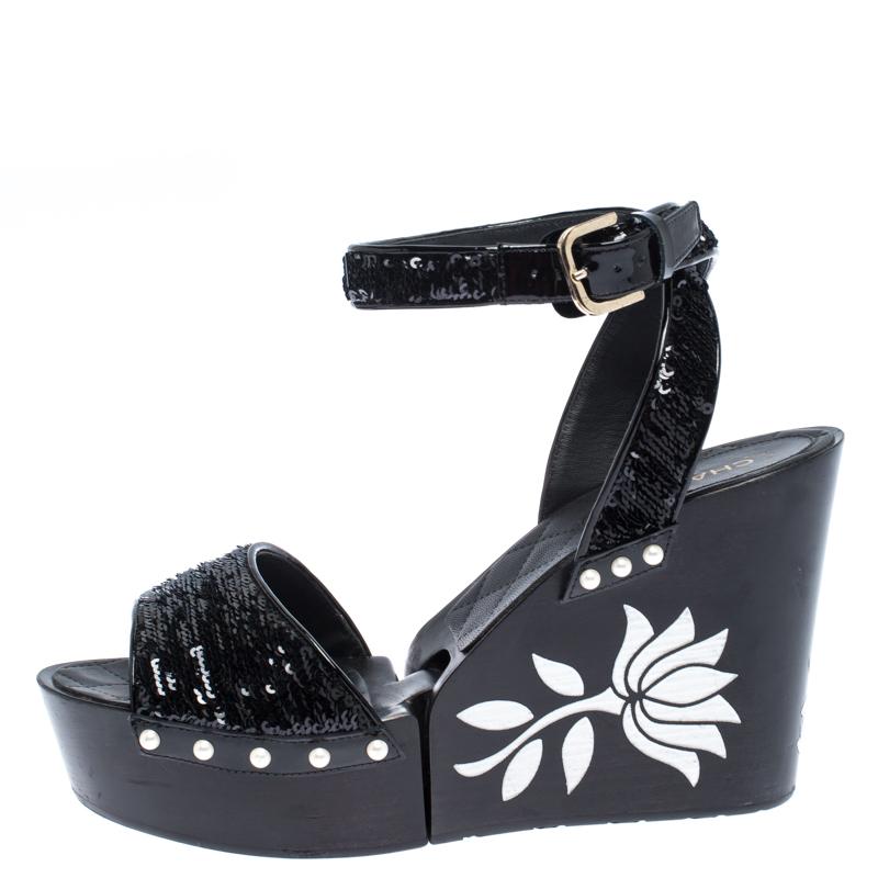 These stylish sandals come from the iconic house of Chanel. They will make your feet look pretty and feel comfortable all day long. Crafted from black sequins, they feature open toes, vamp straps, buckled ankle straps, pearl detailing as well as