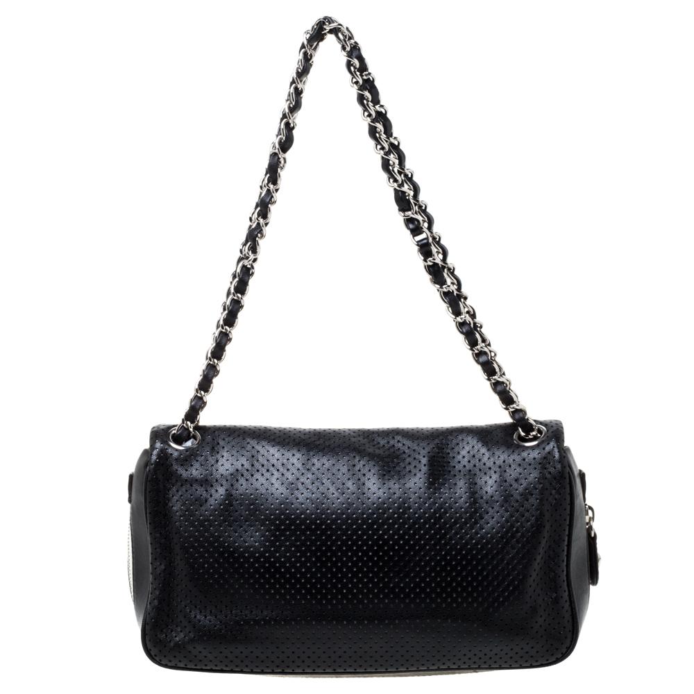 Ace the styling game by carrying this flap bag from Chanel. Made from black perforated leather, the bag features double chain-link shoulder straps, and the base is highlighted with zipper details. The front flap comes with a CC turn-lock in