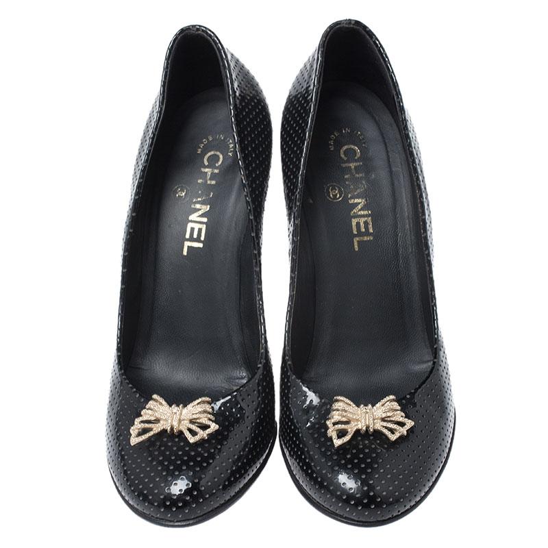 Be the lady in black with these pumps from Chanel. They've been crafted from perforated leather and designed with round toes, 10 cm heels, and embellished bows on the uppers and counters. Get ready to strike the best pose with this number!

