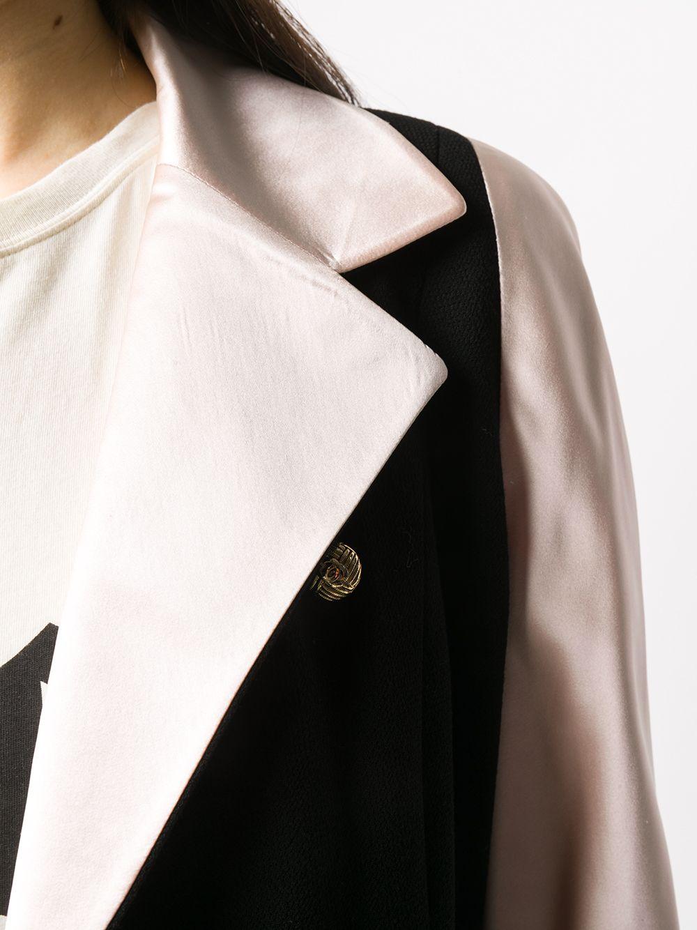 Meticulously crafted in France from a contrasting two-tone palette of pure black wool and pink silk, this sophisticated pre-loved skirt suit by Chanel gives a 90s-inspired twist to the brand's signature twinset. The blazer features peaked lapels, a