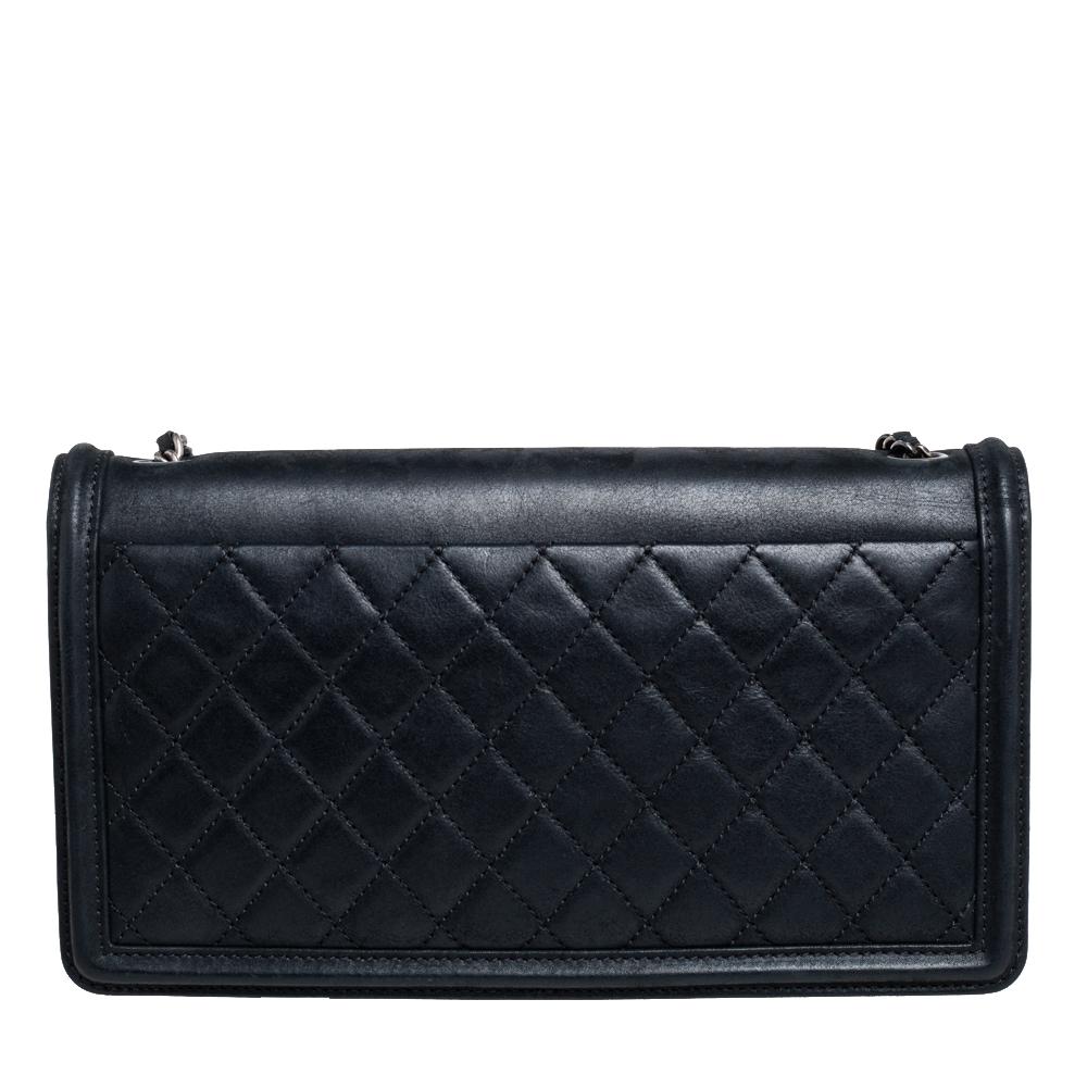 The Chanel Boy Brick bag comes as a fine update of the Boy flap bag. Designed in similarity with Chanel's Lego clutch, the bag has a plexiglass panel on the flap detailed with the CC logo and metal corners. The leather bag has quilting on the back