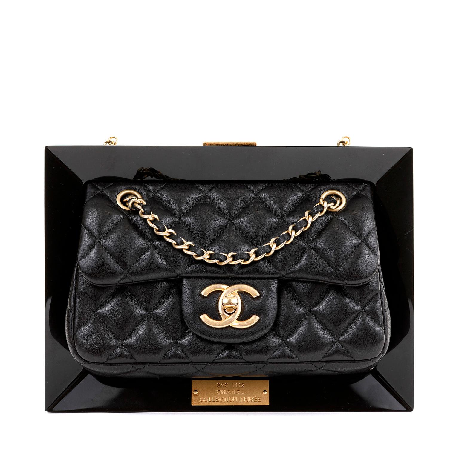 This authentic Chanel Black Privée Collection Frame Bag is in pristine condition.  Considered an extremely rare Runway collectible, this Chanel bag is completely unique.

Black quilted lambskin flap bag is attached to slim Plexiglass frame.  Gold