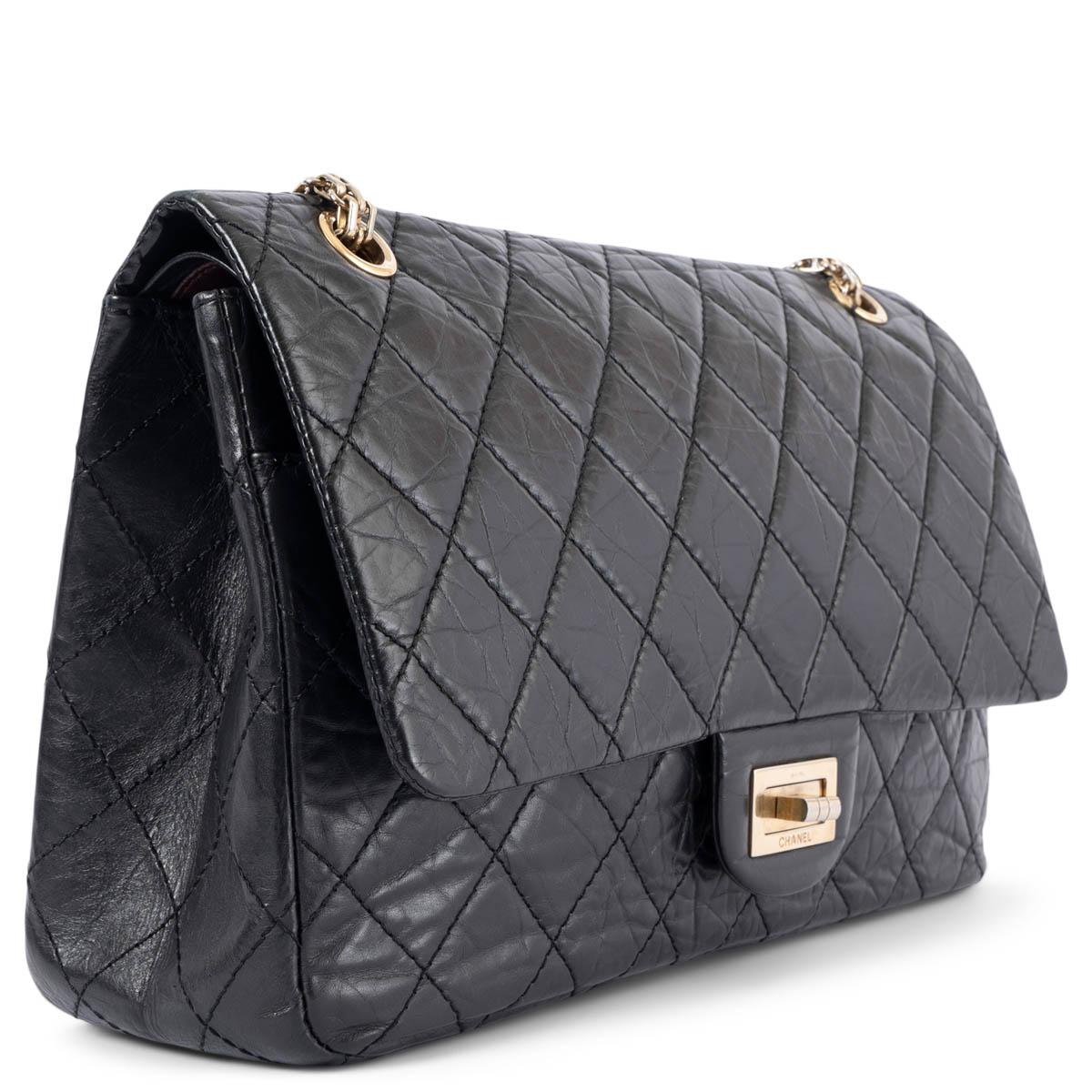 100% authentic Chanel 2.55 Reissue 227 double flap bag in black aged calfskin featuring classic diamond quilted stitchings. Opens with a turn-lock to a black and burgundy smooth calfskin interior with two patch pockets and one lipstick pocket