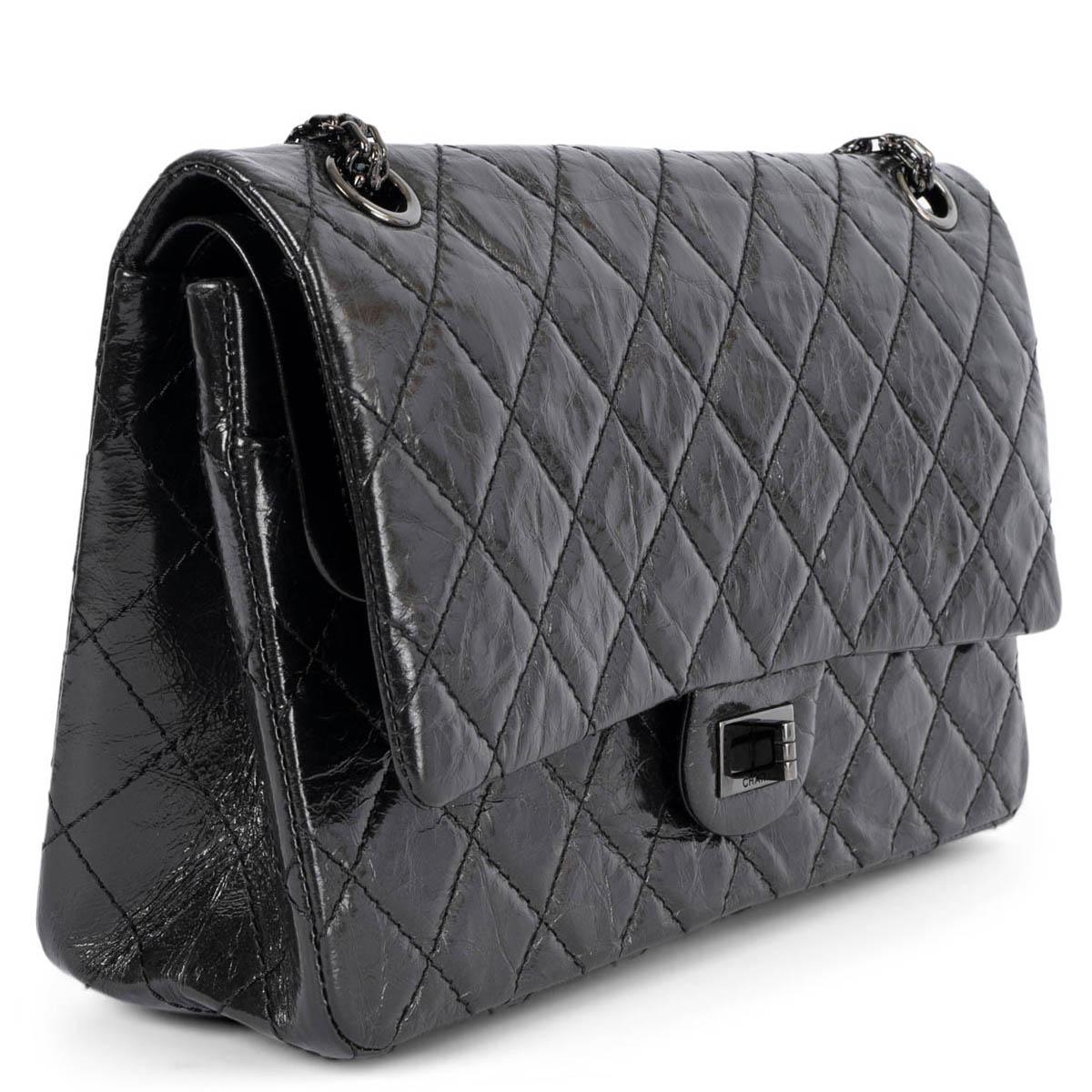 100% authentic Chanel 2.55 Reissue 226 double flap bag in black aged calfskin featuring classic diamond quilted stitchings. Opens with a black metal turn-lock to a black smooth calfskin interior with two patch pockets and one lipstick pocket against