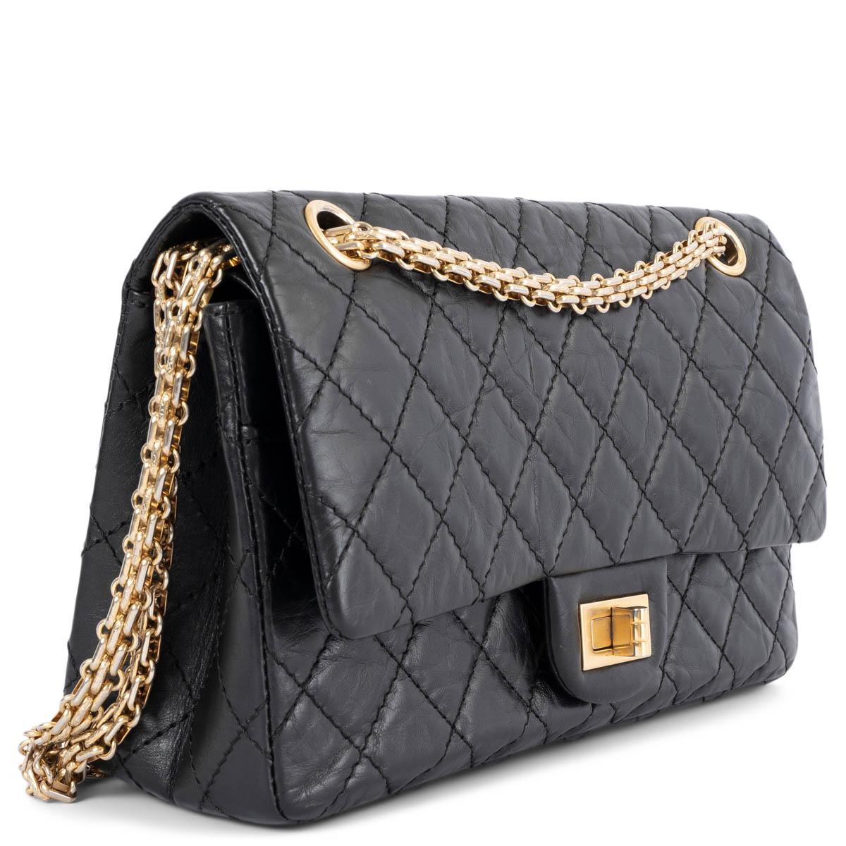 100% authentic Chanel 2.55 Reissue 225 double flap bag in black aged calfskin featuring classic diamond quilted stitchings. Opens with a turn-lock to a black and burgundy smooth calfskin interior with two patch pockets and one lipstick pocket