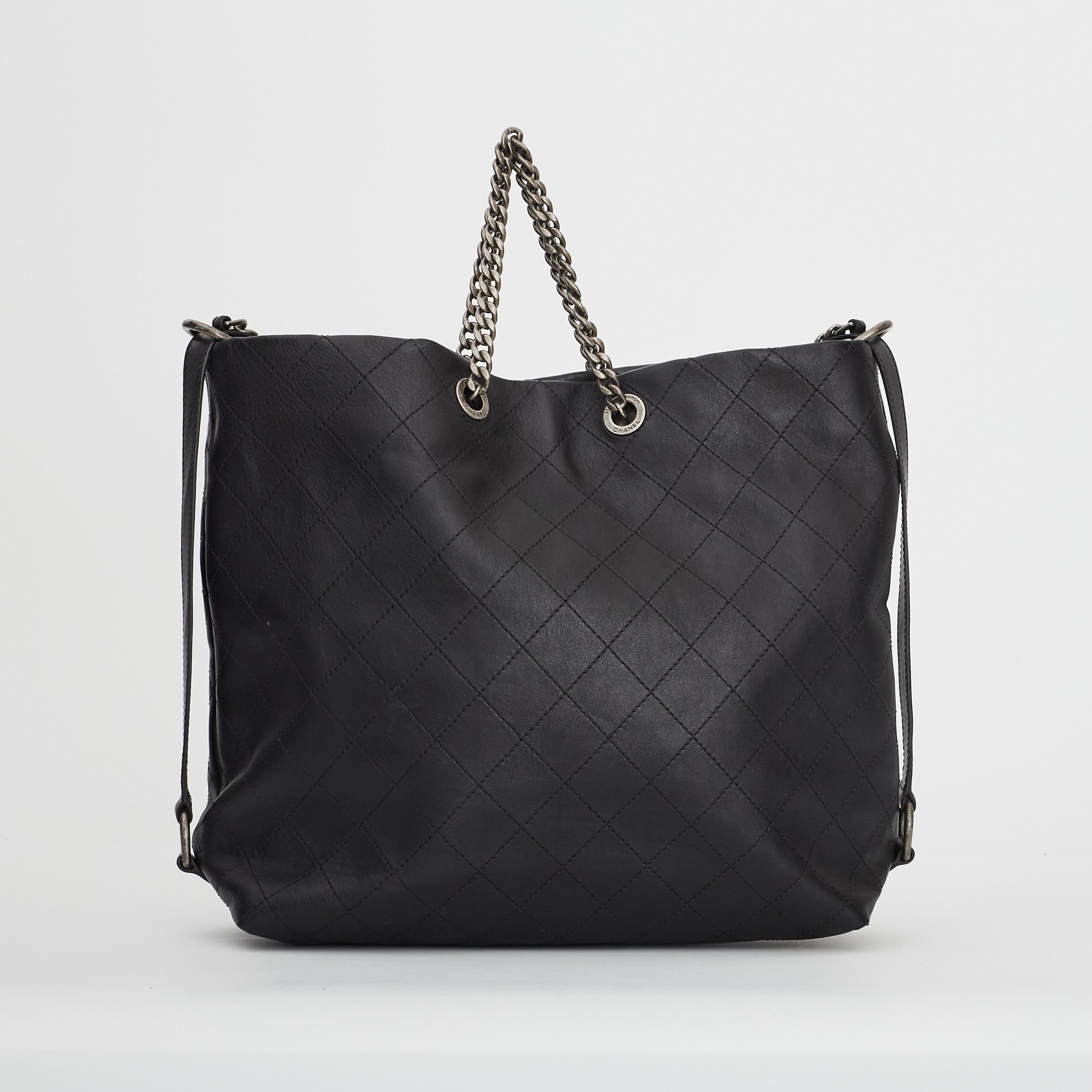 From the 2017 collection. This Chanel hobo bag is made with soft quilted calfskin leather in black with a slouching shape. The bag features ruthenium (gunmetal) hardware, a long flat leather shoulder or cross body strap, chain top handles, a