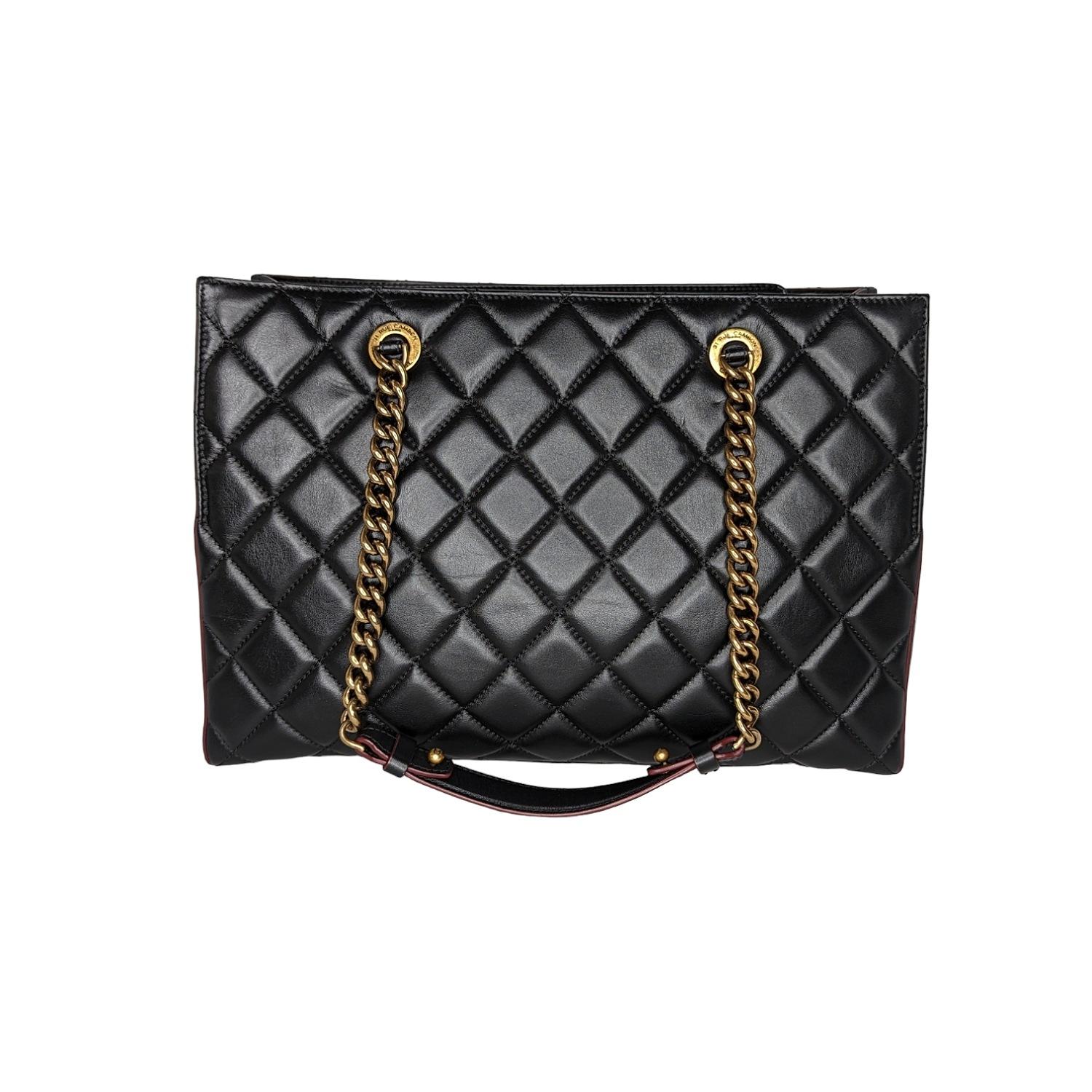 From the Pre-Fall 2012 Collection by Karl Lagerfeld. This edgy newer style features luxurious calfskin leather in signature diamond shaped quilting with a burgundy trim. The shoulder straps are crafted of a prominent aged brass chain strap with a