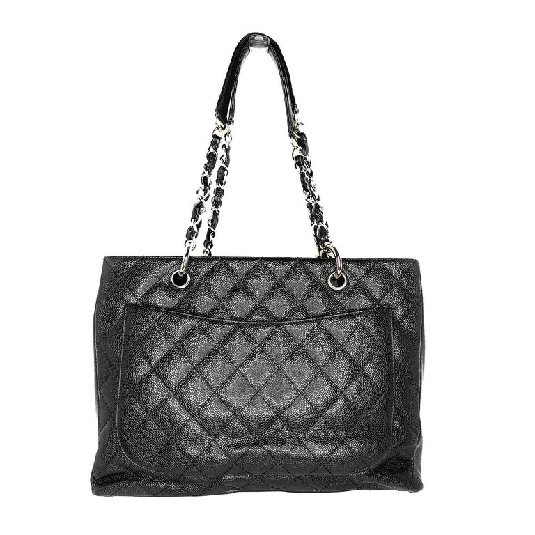 This stylish tote is crafted of diamond-quilted caviar leather in black. This shoulder bag features leather-threaded polished silver chain-link shoulder straps with shoulder pads, a quilted Chanel CC logo on the front, and a flat pocket on the rear.