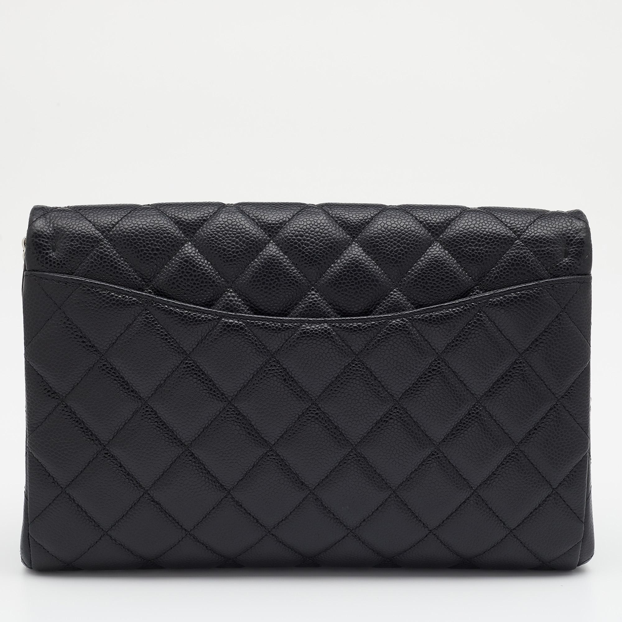 You cannot go wrong with this Chanel clutch bag. Crafted in Italy, it is made from quilted Caviar leather and flaunts a shade of black, and has a structured silhouette. It is held by a single handle and leads to a roomy interior with enough space