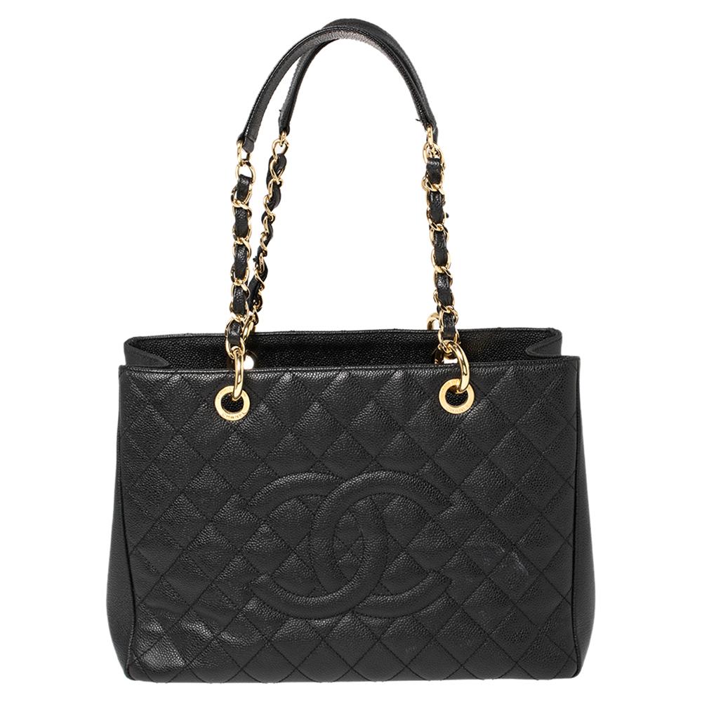 Featuring top handles with chain trim and the CC logo on a quilted pattern, this Chanel black Caviar leather tote exudes just the right amount of sophistication. The bag features an open-top, with a spacious compartment divided by a zipper. It has