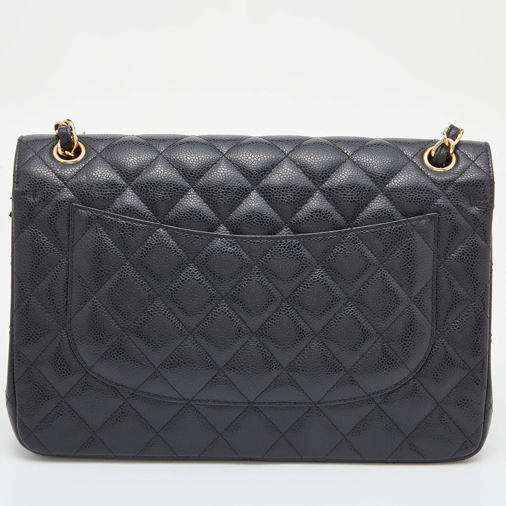 Chanel's luxurious Classic Flap bag is a must-have in a well-curated wardrobe! This stunning bag has a masterfully-crafted leather exterior with gold-tone hardware and the iconic CC logo on the front. This Jumbo Classic Double Flap is complete with