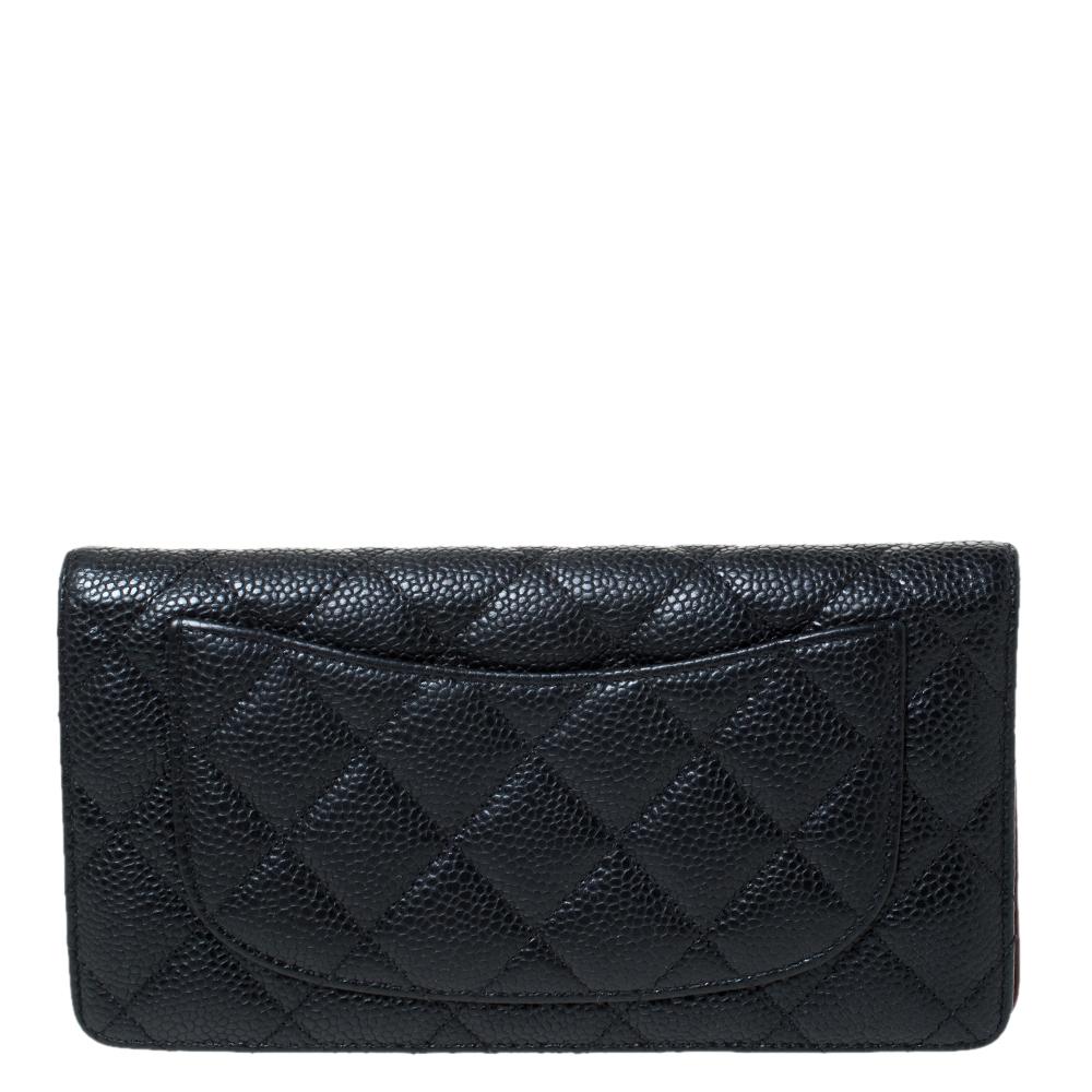 This Yen wallet from Chanel is a wonderful creation! This black wallet is crafted from Caviar leather and features the signature quilted pattern all over the exterior along with the CC logo to the front. The bi-fold piece opens to a leather and