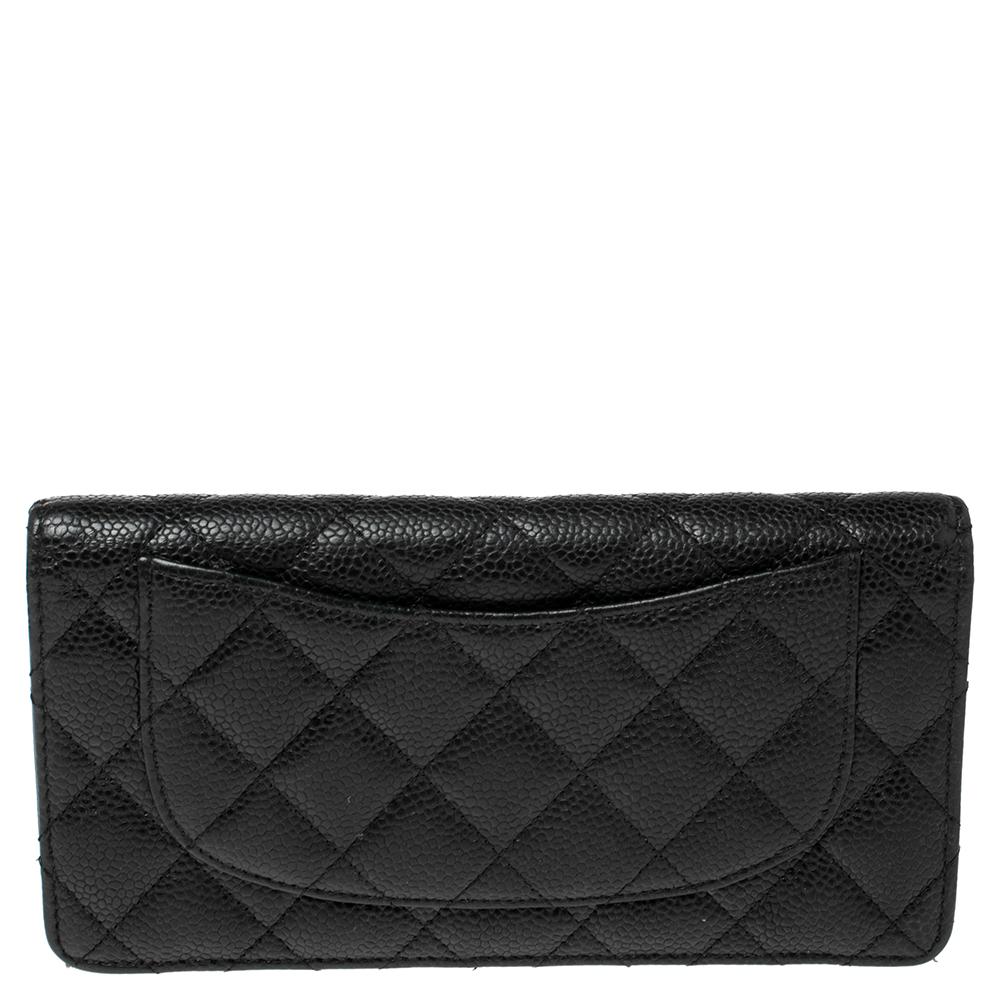 Complete your everyday Chanel edit with this Yen continental wallet. This black wallet is crafted from Caviar leather and features the signature quilted pattern all over the exterior along with the CC logo to the front. The bi-fold piece opens to a