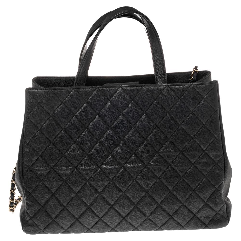 Fashioned using black quilted Caviar leather into a practical size, this Chanel Business Affinity shopper tote has high style and a timeless charm. It is highlighted with a gold-tone CC logo lock and a zip pocket at the front. The interior is lined