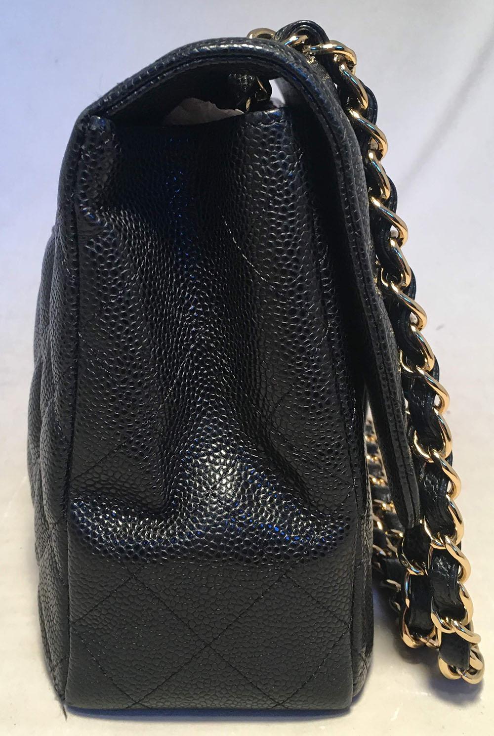 Chanel Black Quilted Caviar Leather Maxi Classic Flap Shoulder Bag in excellent condition. Black quilted caviar leather exterior trimmed with gold hardware. Signature CC logo twist closure opens via single flap to a black leather lined interior that