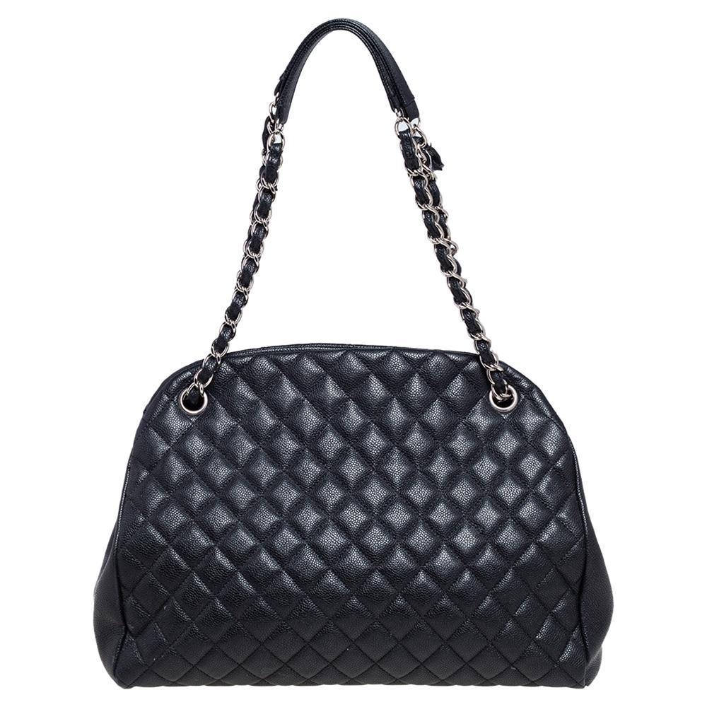 Spacious and lovely, this Just Mademoiselle Bowler bag is from Chanel. It has been crafted from black Caviar leather in its signature quilt pattern and enhanced with silver-tone hardware. It is equipped with chain handles and fabric compartments.