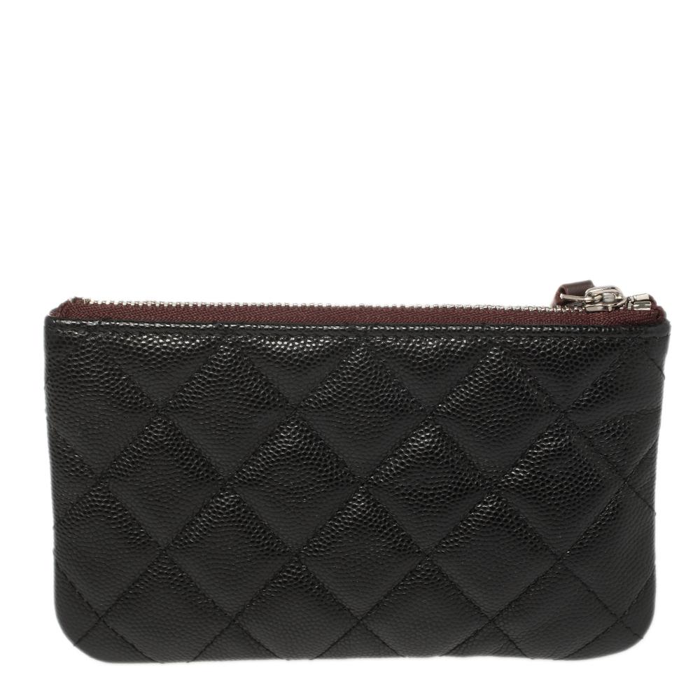 This Mini O-Case pouch from Chanel is made using Caviar leather into a simple shape. It has a fabric-lined interior that is secured by a top zip closure. This pouch is covered in the brand's diamond quilt and finished with the CC logo.

Includes: