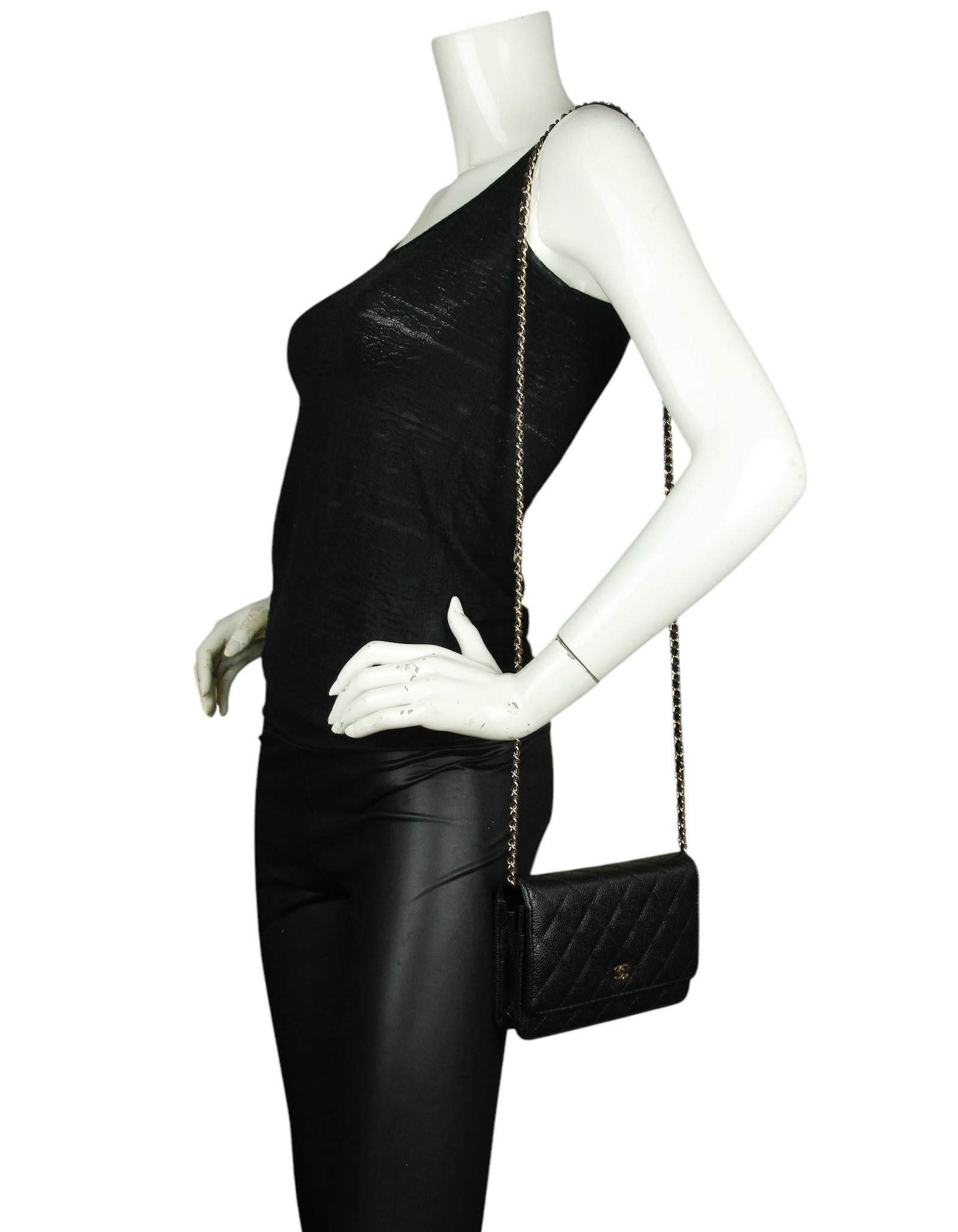 Chanel Black Quilted Caviar Leather Wallet On Chain WOC Crossbody Bag. Chain can be tucked inside bag to also be worn as a clutch. 

Made in: Italy
Color: Black
Hardware: Goldtone
Materials: Caviar leather
Lining: Leather and