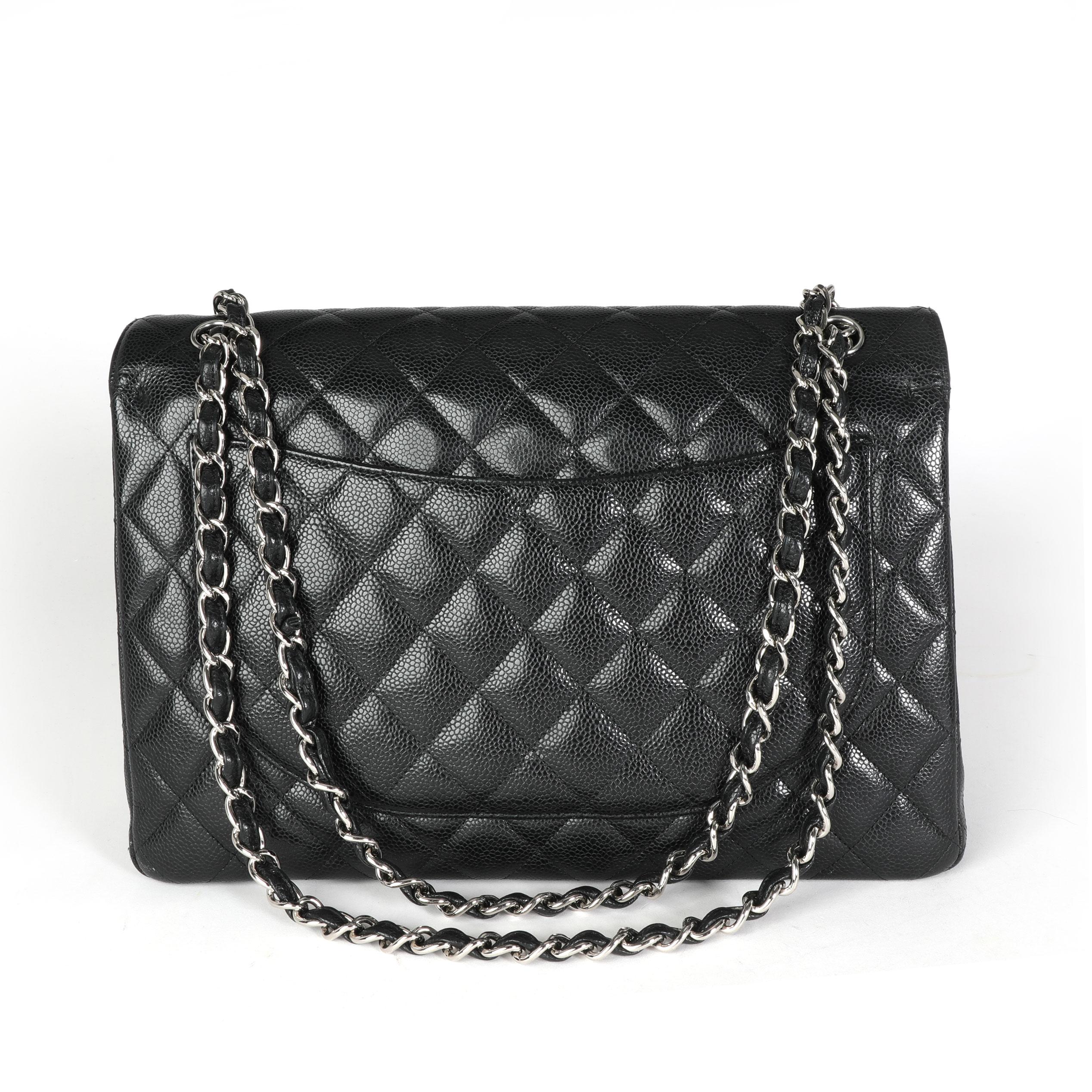 Chanel Black Quilted Caviar Maxi Classic Double Flap Bag In Excellent Condition In New York, NY