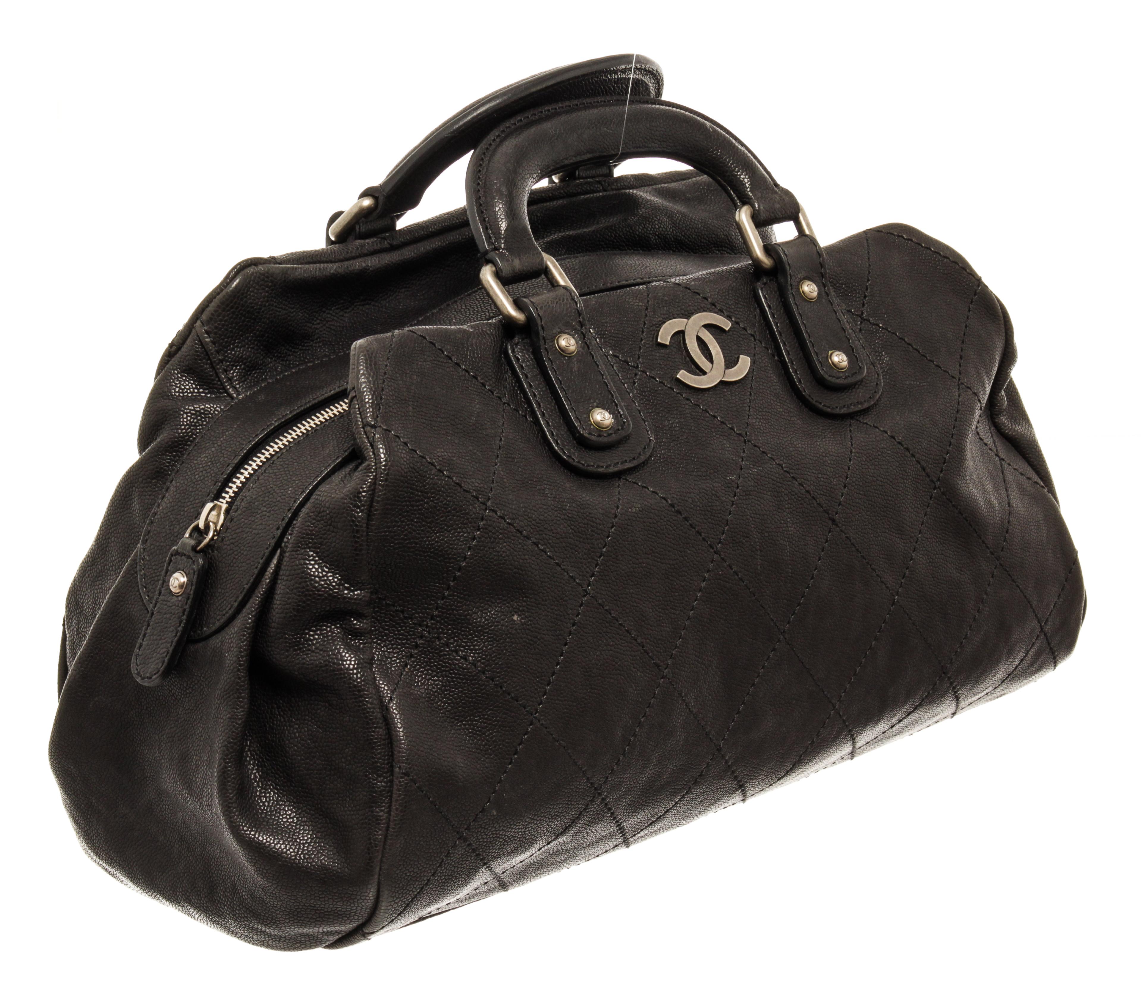 Chanel Black Quilted Caviar Outdoor Ligne Small Doctor Bag with silver-tone hardware, metal foot base, black fabric lining, interior zip pocket, dual rolled leather top handles, and zip closure at the top.

76570MSC.