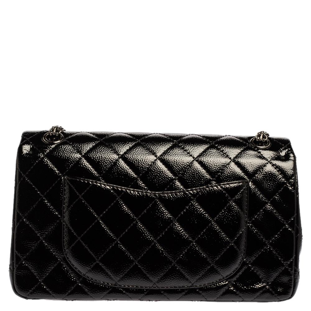 Chanel's Flap bags are iconic and noteworthy in the history of fashion. Hence, this Reissue 2.55 is a buy that is worth every bit of your splurge. Exquisitely crafted from black caviar patent leather, it bears their signature quilt pattern and the