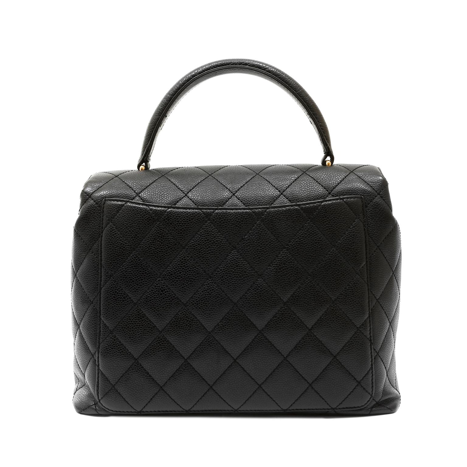 This authentic Chanel Black Quilted Caviar Top Handle Bag is in excellent condition from the early 2000's.  Perfectly scaled, this ladylike silhouette is able to transition easily from day to evening all year long.
Durable and textured black caviar