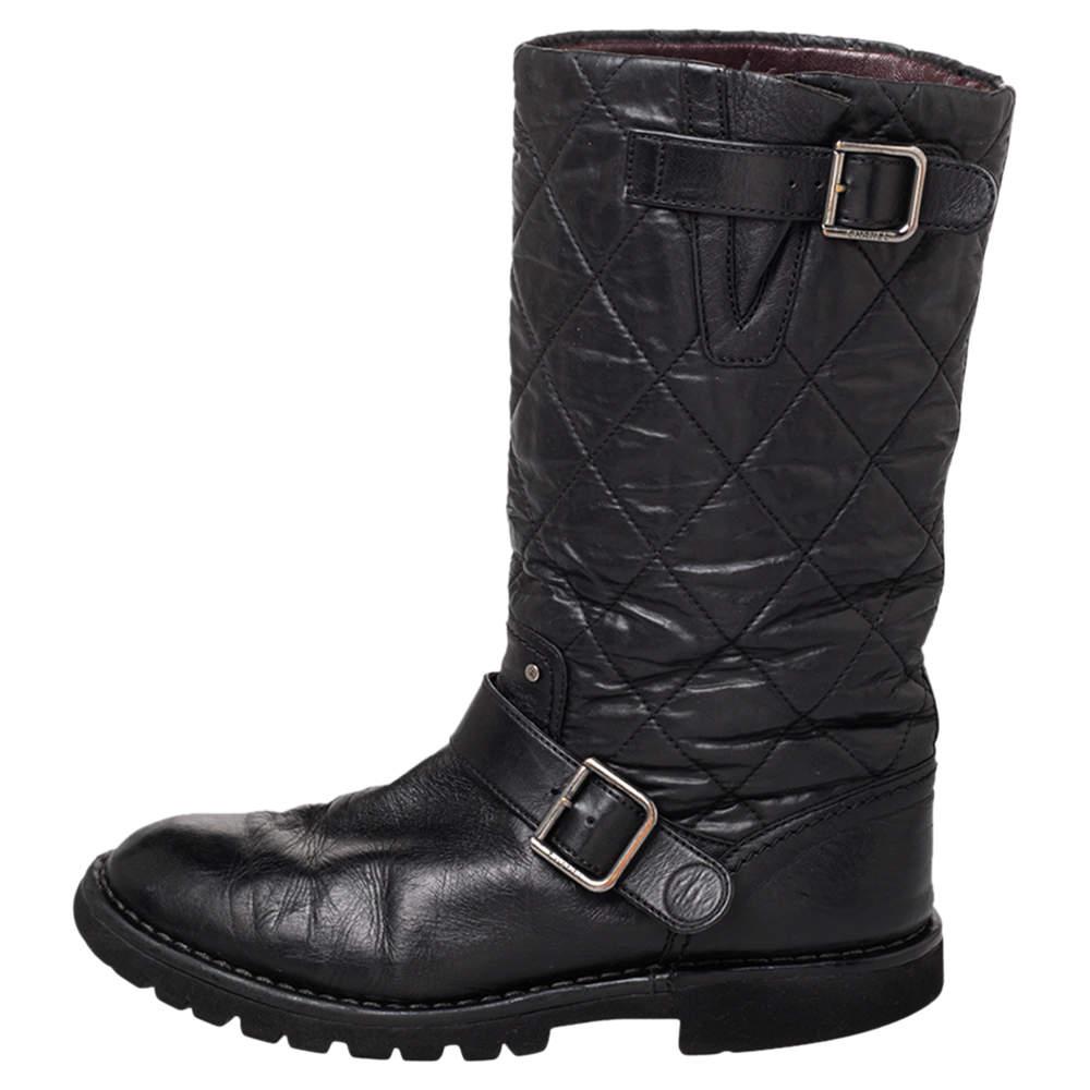 These Chanel boots embody excellence in design and craftsmanship. Crafted from quilted fabric and leather, the mid-calf boots arrive in black. They feature round toes, signature quilt, buckle details, and tough soles.

