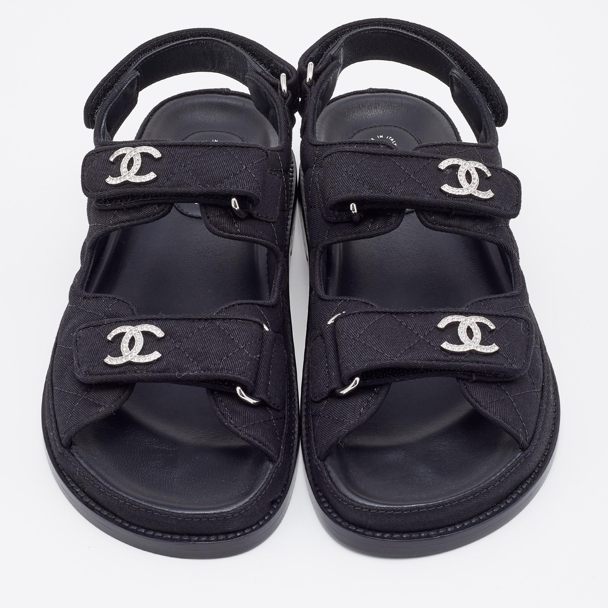 Be warm-weather-ready in the chicest way possible with these stylish Chanel Dad sandals. Fashioned in black quilted fabric with tonal stitching and a CC logo on each Velcro strap, these comfortable sandals also have slingback straps and platforms