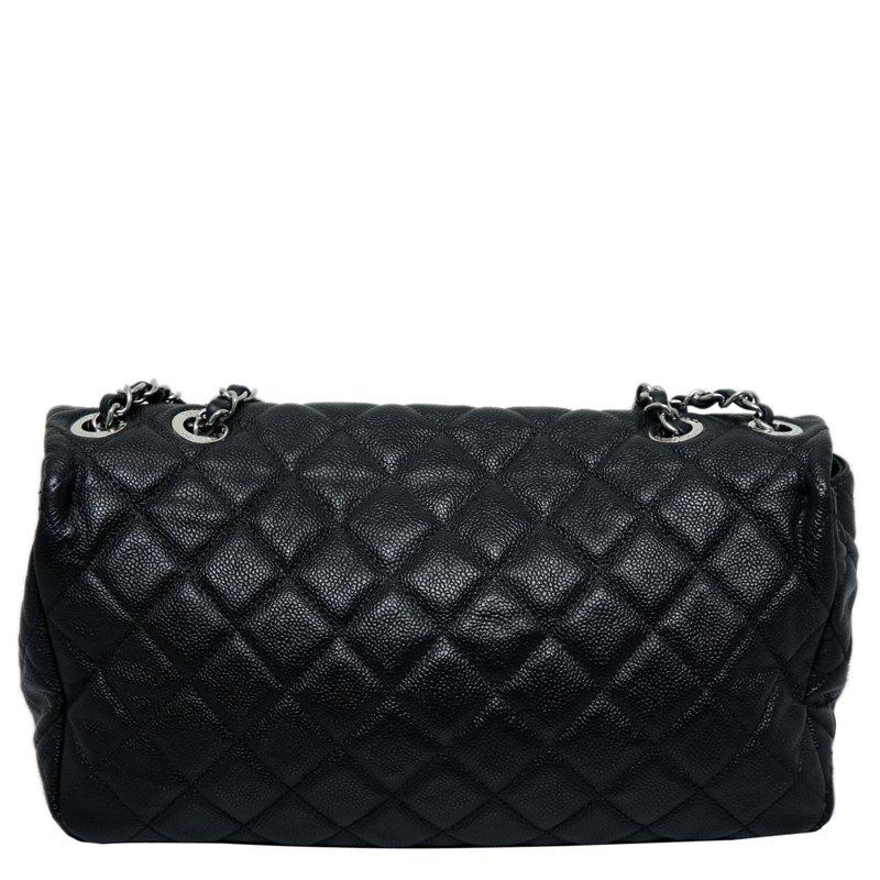 This Classic Flap Bag by Chanel is structured with sophistication. Crafted from black leather, it is accented with quilted details and silver-tone hardware. This bag comes with a chain and leather entwined shoulder strap to keep your hands free. The