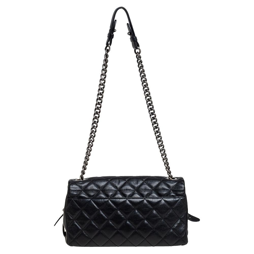 From Chanel’s stunning Pre-Fall Winter 2015 bag collection, this flap bag is simply a delight for the fashionista in you! It has been crafted in black goatskin leather in a quilted pattern. The chain strap and CC push-lock look stylish in