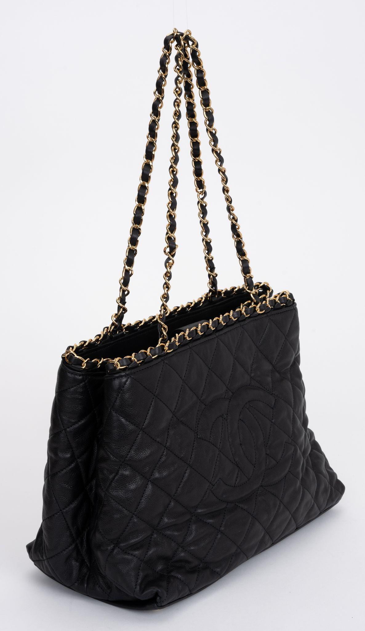 Chanel Calfskin Quilted Small Chain Me Tote in black with an intertwined leather gold shoulder strap. The bag features Chanel CC logo. Interior has one zipper pocket and patch pockets. Shoulder drop 10