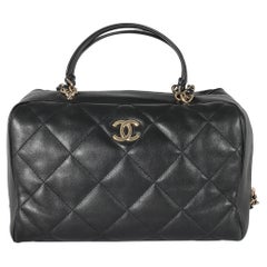 Sold at Auction: Chanel - a small bowling bag in black velour, from the A/W  2021 collection, the quilted cylinder body in camellia design with leather  piping, interlocking CC logo at the