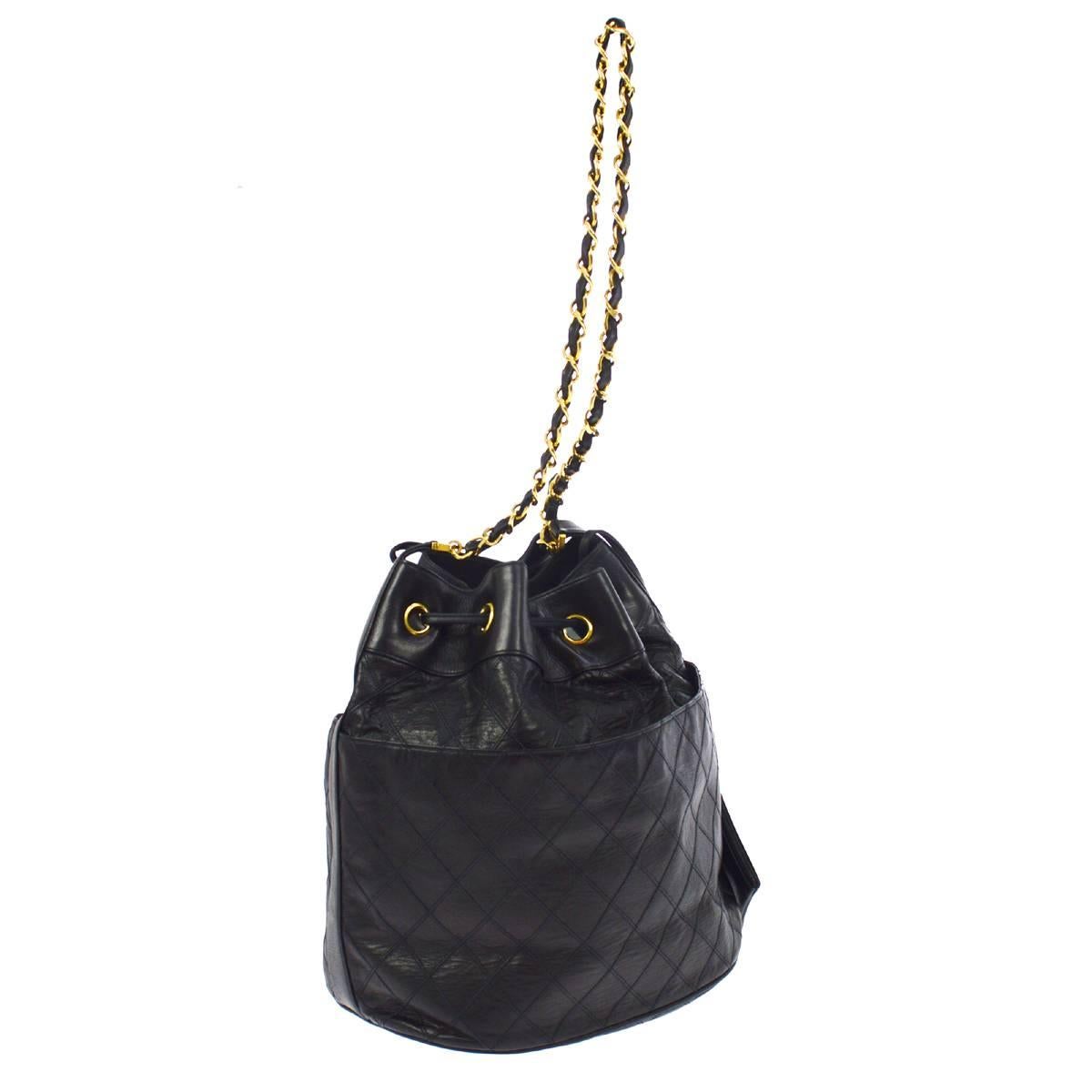 - Vintage 80s Chanel black quilted lambskin bucket shoulder bag. 

- Featuring gold-toned 