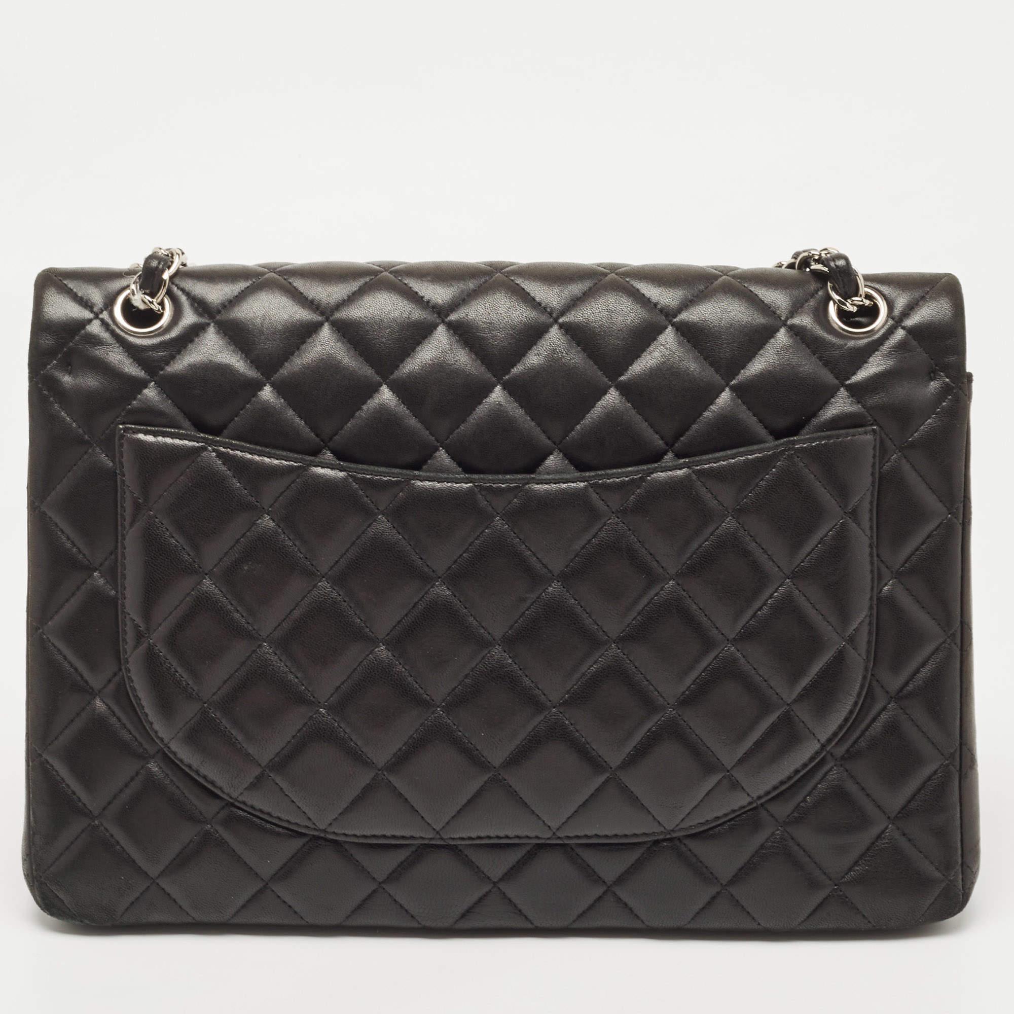 Chanel's luxurious Classic Flap bag is a must-have in a well-curated wardrobe! This stunning bag has a masterfully-crafted leather exterior with silver-tone hardware and the iconic CC logo on the front. This Maxi Classic Double Flap is complete with