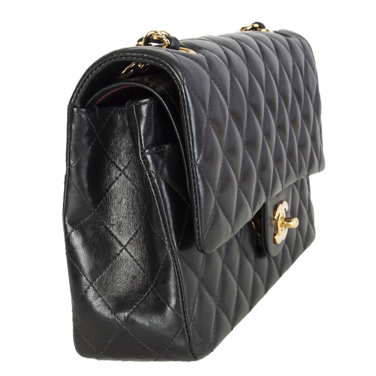 Chanel 'Timeless Classic Flap Medium' shoulder bag in black lambskin featuring gold-tone hardware. Open pocket on the back. Closes with classic CC-turn-lock on the front. Zipper pocket in the flap. Outside pocket on the front under the flap. Lined