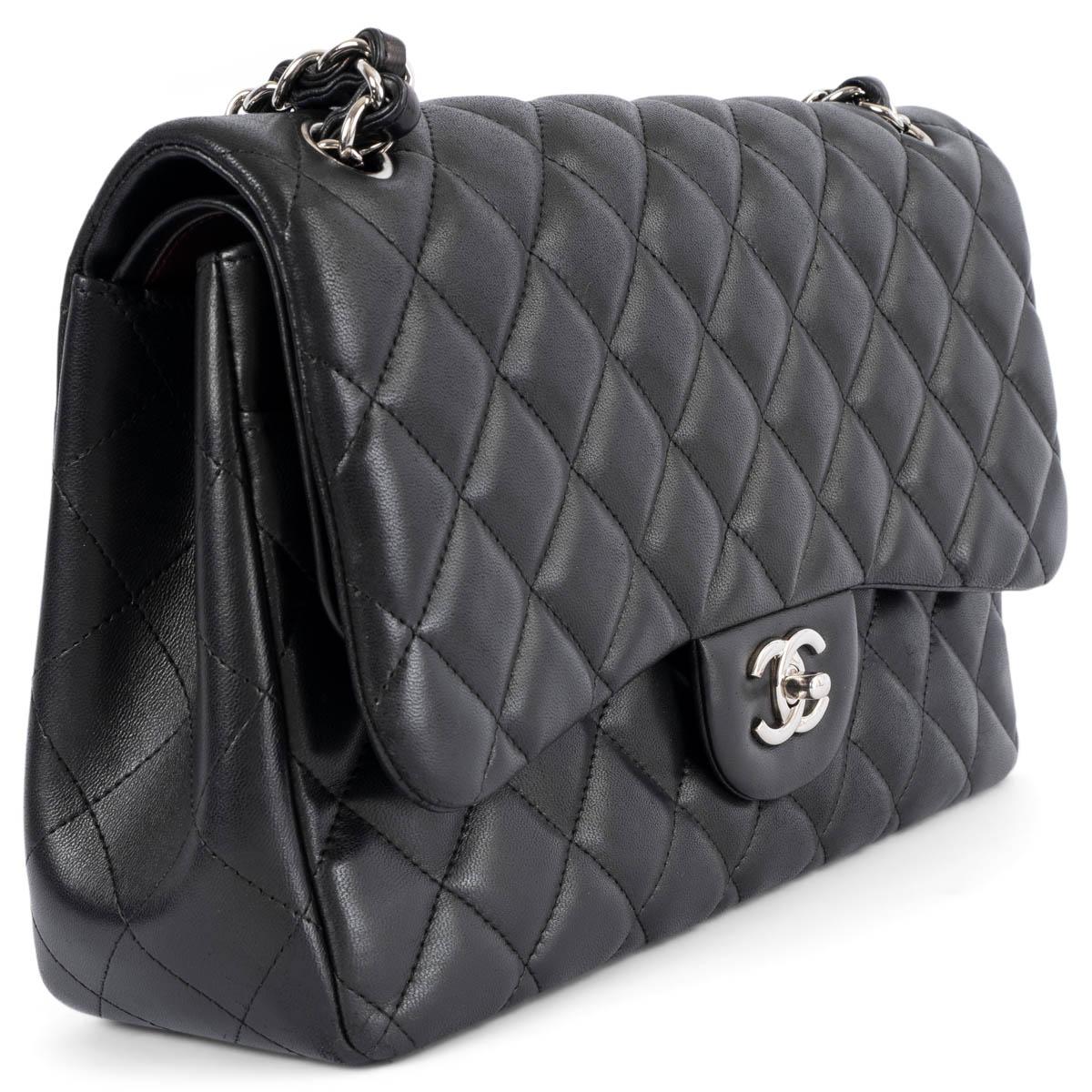 100% authentic Chanel Classic Large Timeless Double Flap shoulder bag in black lambskin featuring silver-tone hardware. Open pocket on the back. Closes with classic CC-turn-lock on the front. Zipper pocket inside the flap. Outside pocket on the