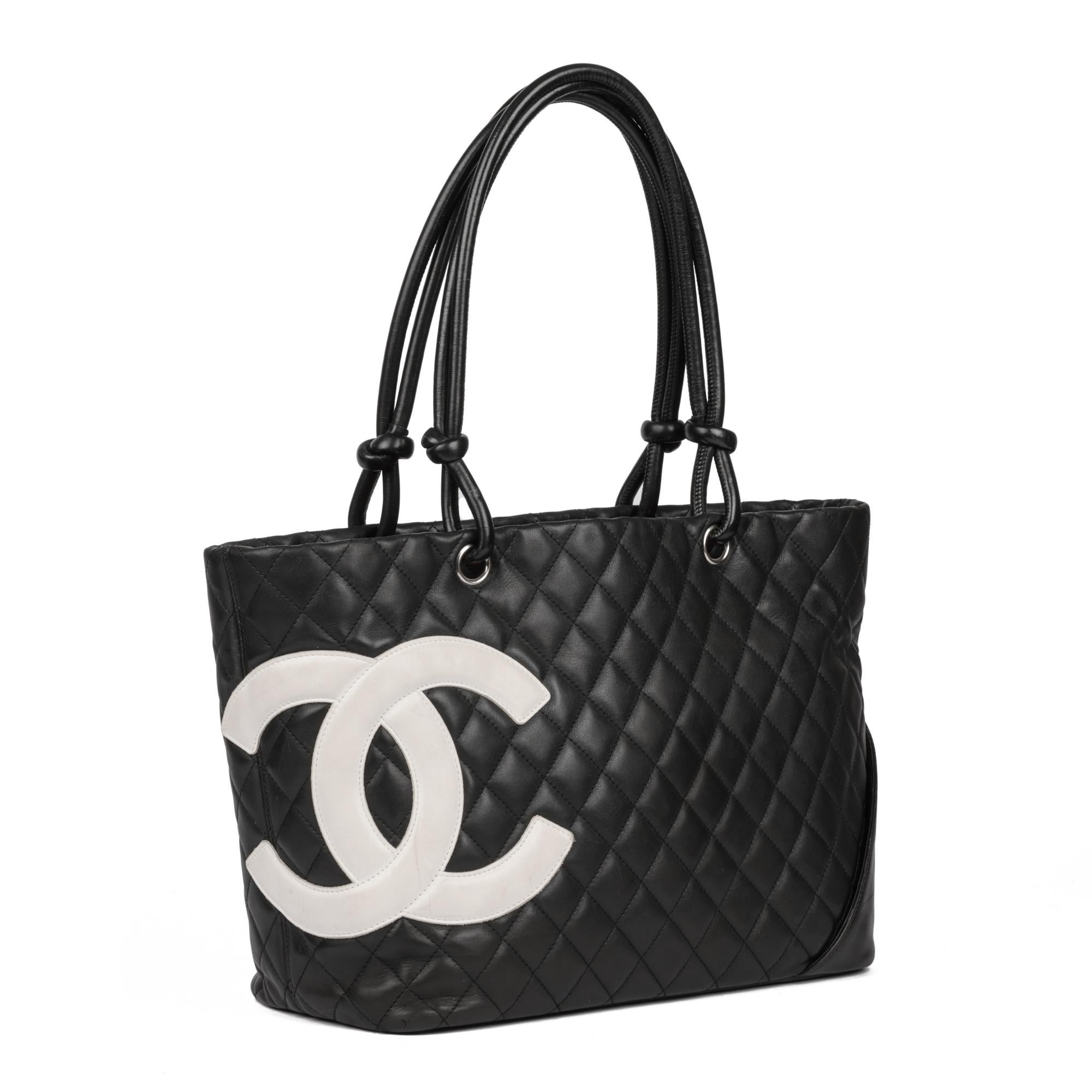 CHANEL
Black Quilted Lambskin Small Cambon Tote Bag 

Xupes Reference: CB858
Serial Number: 10321918
Age (Circa): 2008
Accompanied By: Chanel Dust Bag 
Authenticity Details: Serial Sticker (Made in Italy)
Gender: Ladies
Type: Tote, Shoulder

Colour: