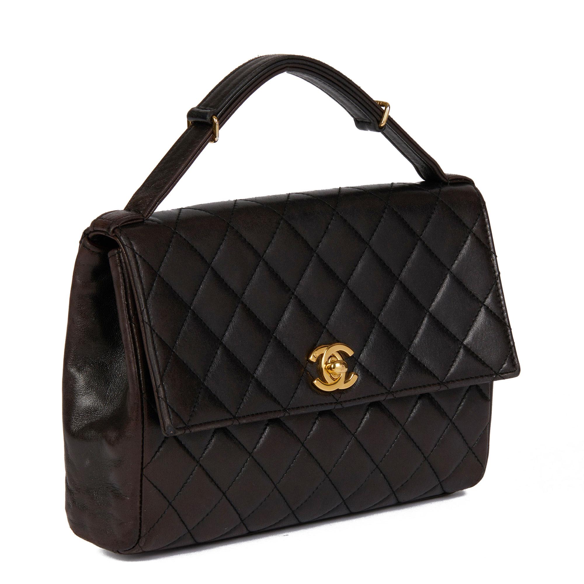 CHANEL
Black Quilted Lambskin Vintage Mini Classic Top Handle Flap Bag

Serial Number: 5475800
Age (Circa): 1997
Accompanied By: Chanel Dust Bag, Authenticity Card, Care Booklet
Authenticity Details: Authenticity Card, Serial Sticker (Made in