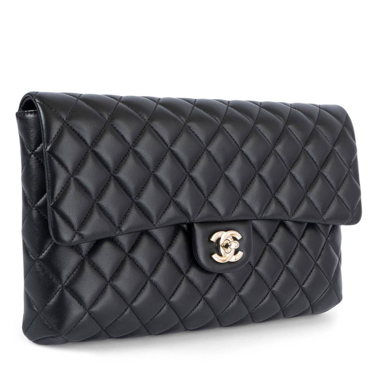 100% authentic Chanel quilted flap clutch in black lambskin leather featuring light gold-tone CC turn-lock closure. Lined in black calfskin with one zipper pocket against the back. Has been carried and is in excellent condition. Comes with dust