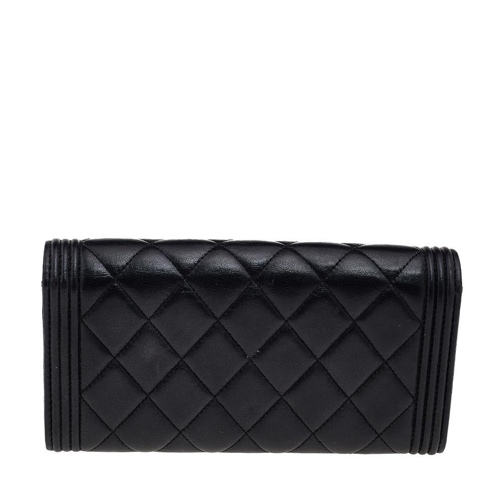 An exemplary and iconic style from Chanel, this Boy wallet is the epitome of grace, elegance, and luxury. It has been created from black quilted leather and enhanced with a gold-toned logo accent. This continental-style wallet comprises of a