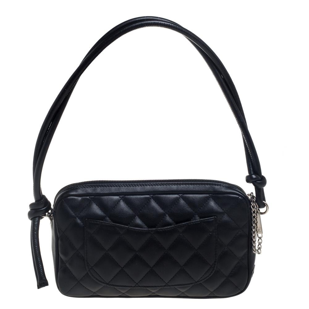 This Chanel Cambon Ligne pochette is conveniently designed for everyday use. Crafted from leather, the exterior has the iconic quilt pattern and the iconic CC logo is detailed on the front. The top zipper opens to a fabric interior for you to neatly