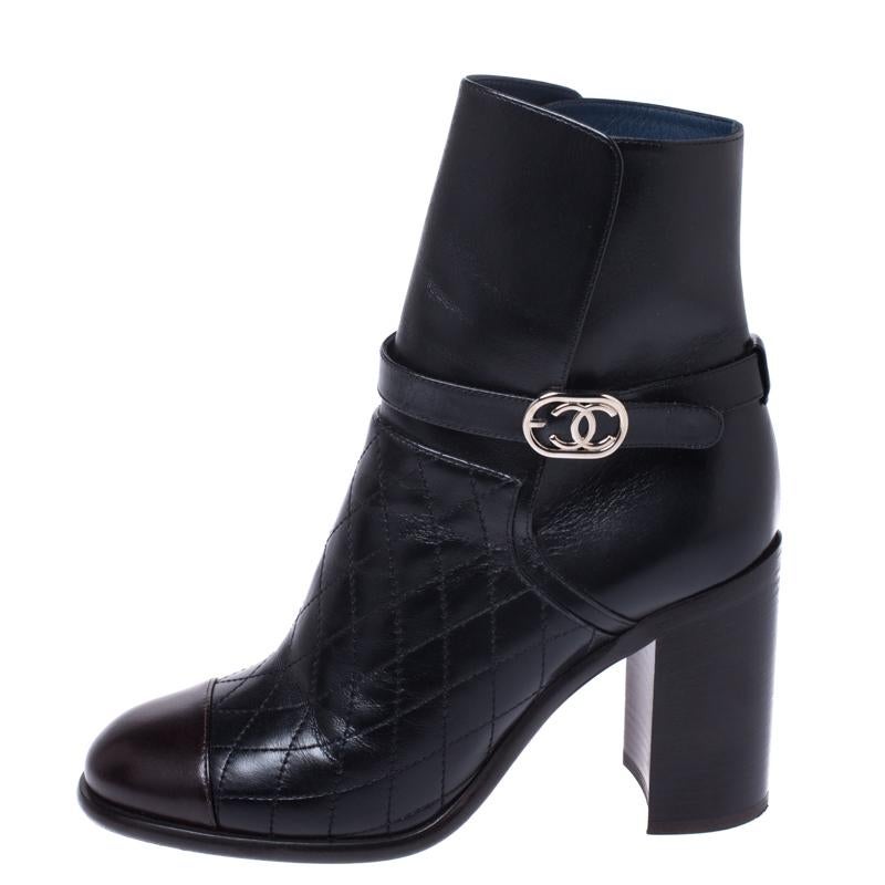 Explore the world of fashion and style with these exclusive ankle boots by Chanel. Make these stylish leather boots yours this season. Crafted in Italy, they are made of quality leather and come in black. They are styled with cap toes, signature