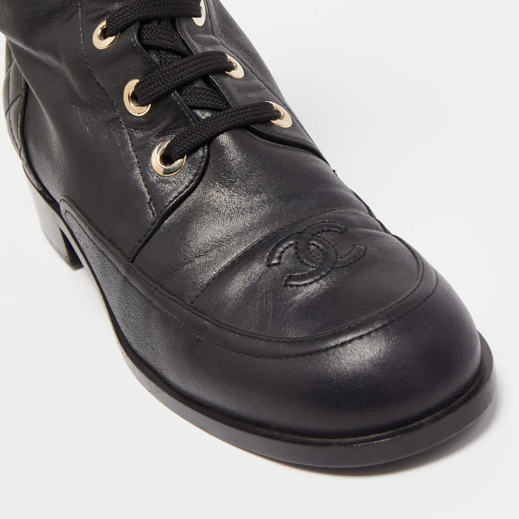 Complete a smart outfit with these black combat boots from Chanel. They're fashioned in leather and secured with simple lace-ups on the uppers.

