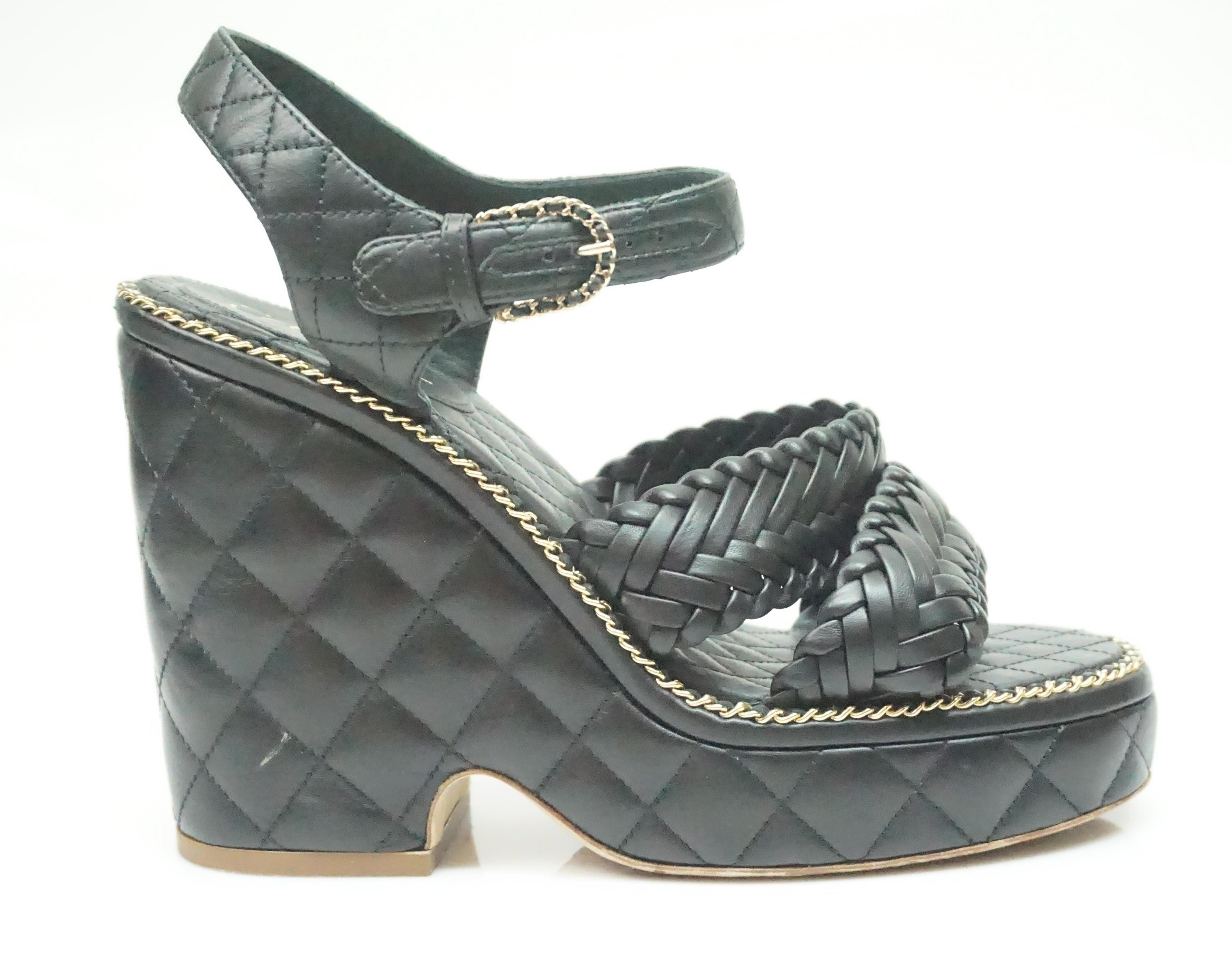 These gorgeous Chanel wedges are in great condition. They are slightly used with small smudges (shown in picture). The wedges are quilted leather with Chanel chain detail around edges and buckle. The double straps are braided leather and the ankle
