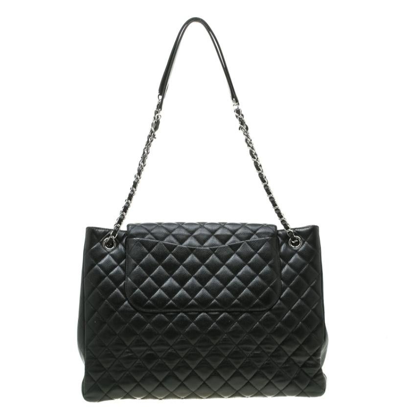 Praise the beauty of this Chanel bag crafted from black quilted leather. The bag features a chain and leather interwoven shoulder strap along with the CC twist lock closure in silver-tone. The flap opens to a fabric-lined interior with enough space