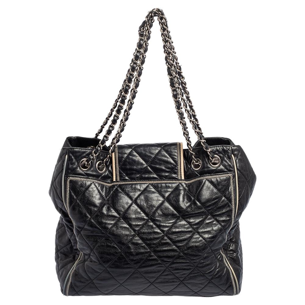 Carry this East West tote from Chanel to all your fashionable outings. This beautiful black tote is crafted from leather and features quilt detailing and chain and leather woven handles. It flaunts the signature lock on the flap and comes equipped