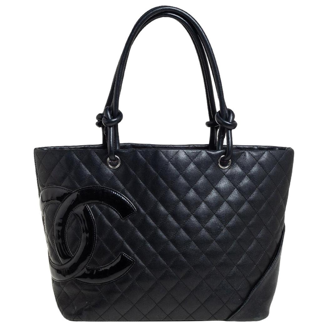 Radiate with classic style when you swing this Ligne Cambon tote from Chanel. Beautifully crafted from leather in black, and designed with quilts all over and the CC logo in patent leather on the side, this tote is a beauty. The bag opens to a